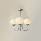 Glass-shade chandelier casting a warm glow in a living room