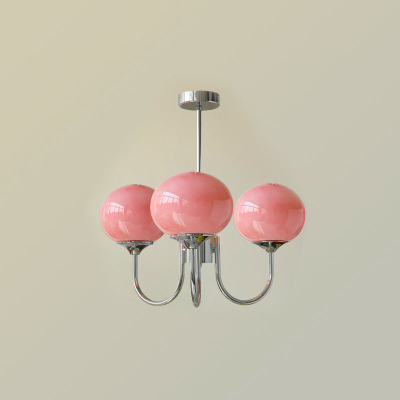 Glass-shade chandelier lit above a console in a refined room
