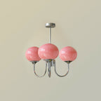 Glass-shade chandelier lit above a console in a refined room