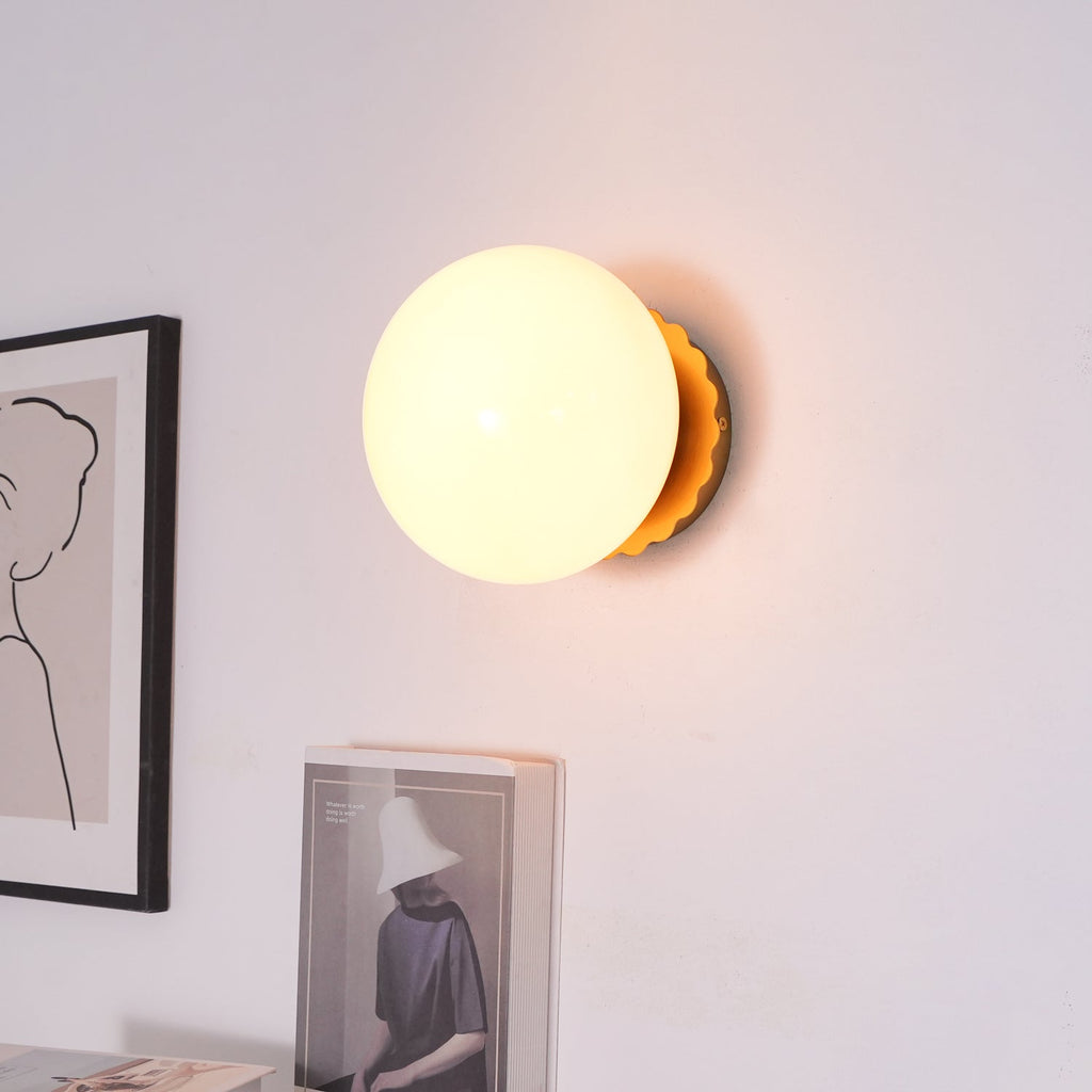 Wall sconce with soft glass diffuser in a bright room
