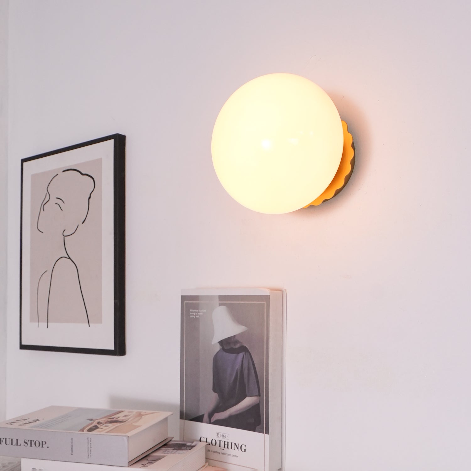 Tinted glass sconce glowing warm beside a doorway