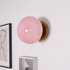 Marshmallow sconce with rounded glass shade and gold body