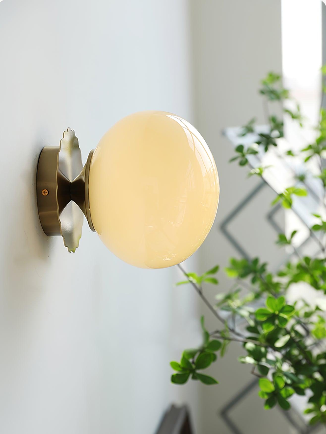 Tinted glass sconce with metal body shown from the side