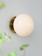 Glass-diffuser wall sconce casting a soft mood glow