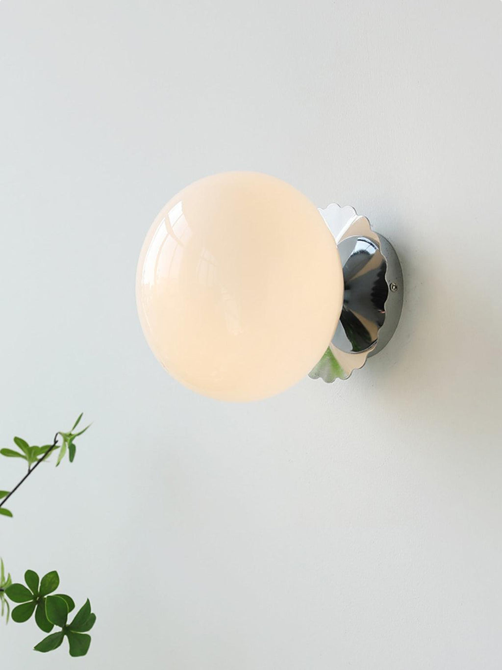 Rounded glass sconce mounted on a wall in a warm interior