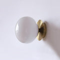 Marshmallow wall sconce with tinted glass diffuser and metal body