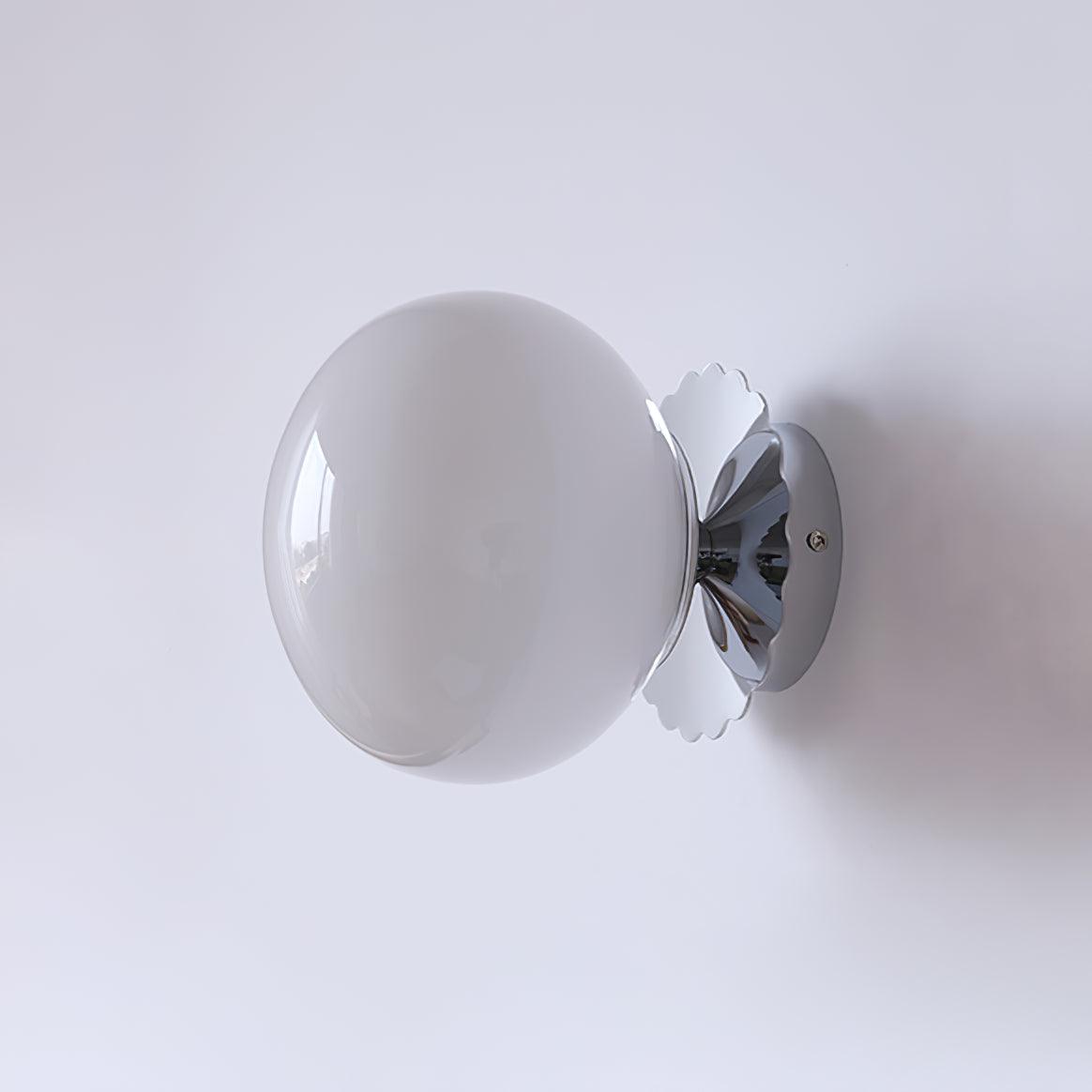 Marshmallow sconce casting a gentle glow in a styled room
