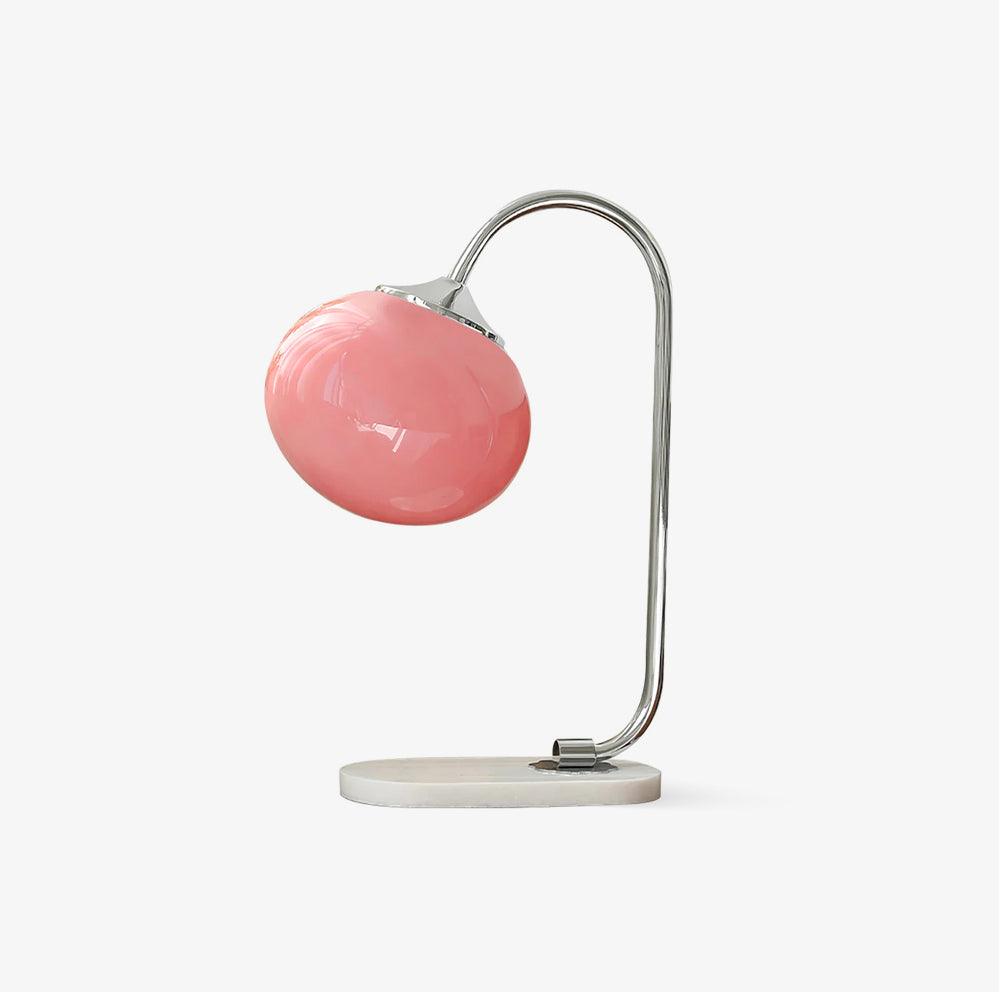 Clérachic pastel glass table lamp with a blush pink globe shade on a chrome arm and white marble base, photographed on a plain grey backdrop.