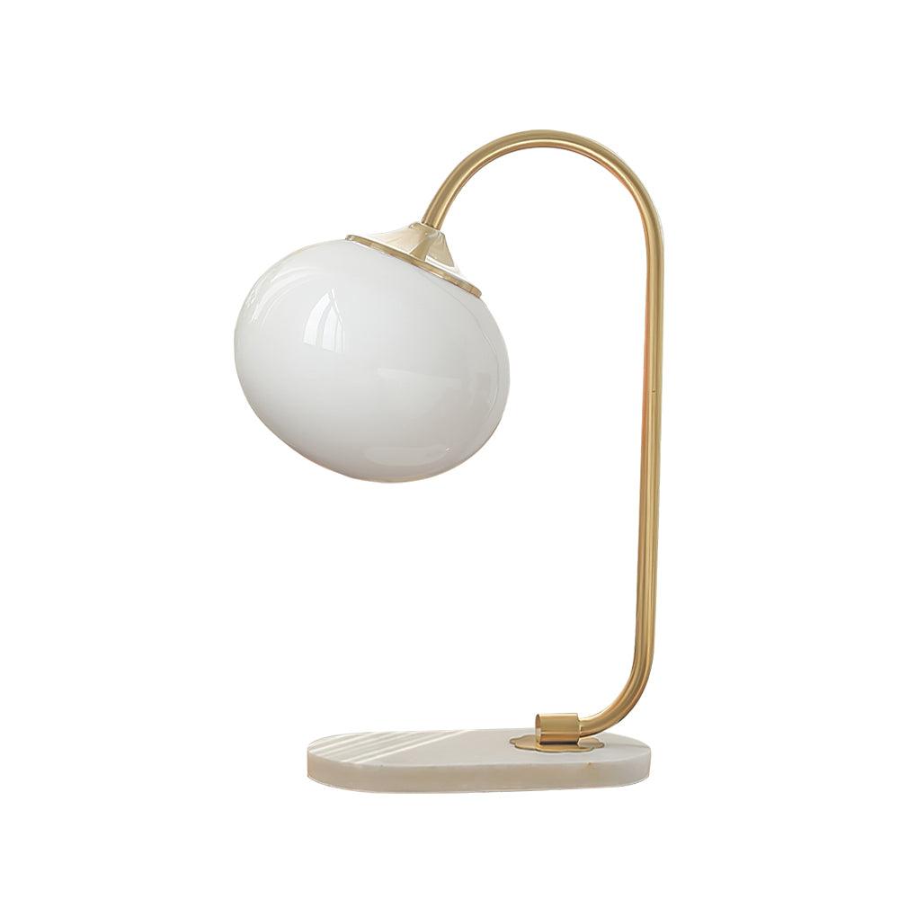 Clérachic pastel glass table lamp with a white globe shade on a gold arm and marble base, shown unlit on a plain white backdrop.