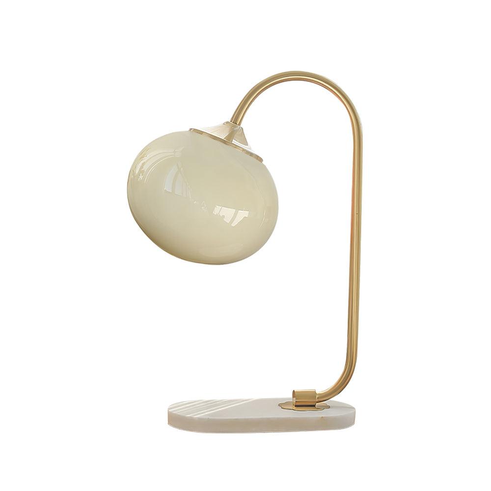 Clérachic pastel glass table lamp with a cream glass shade on a gold arm and marble base, photographed unlit against plain white.