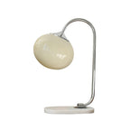 Clérachic pastel glass table lamp with a cream glass shade on a chrome arm and marble base, shown unlit on a plain white backdrop.
