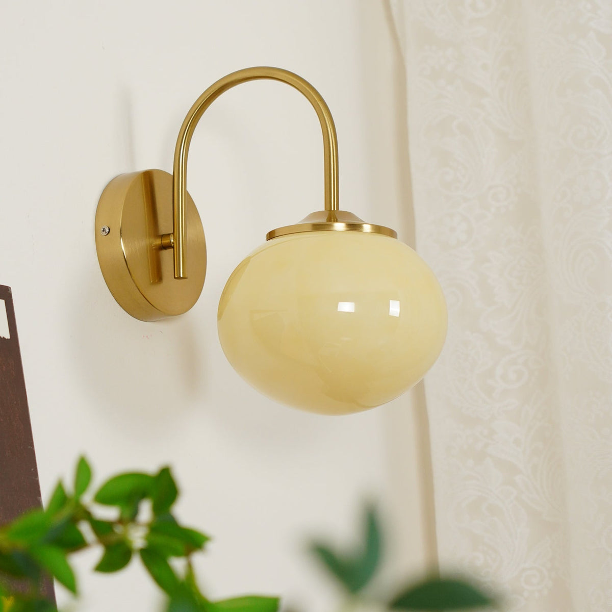 Front view of this Clérachic wall light in copper and beige glass, unlit, on a plain white wall.
