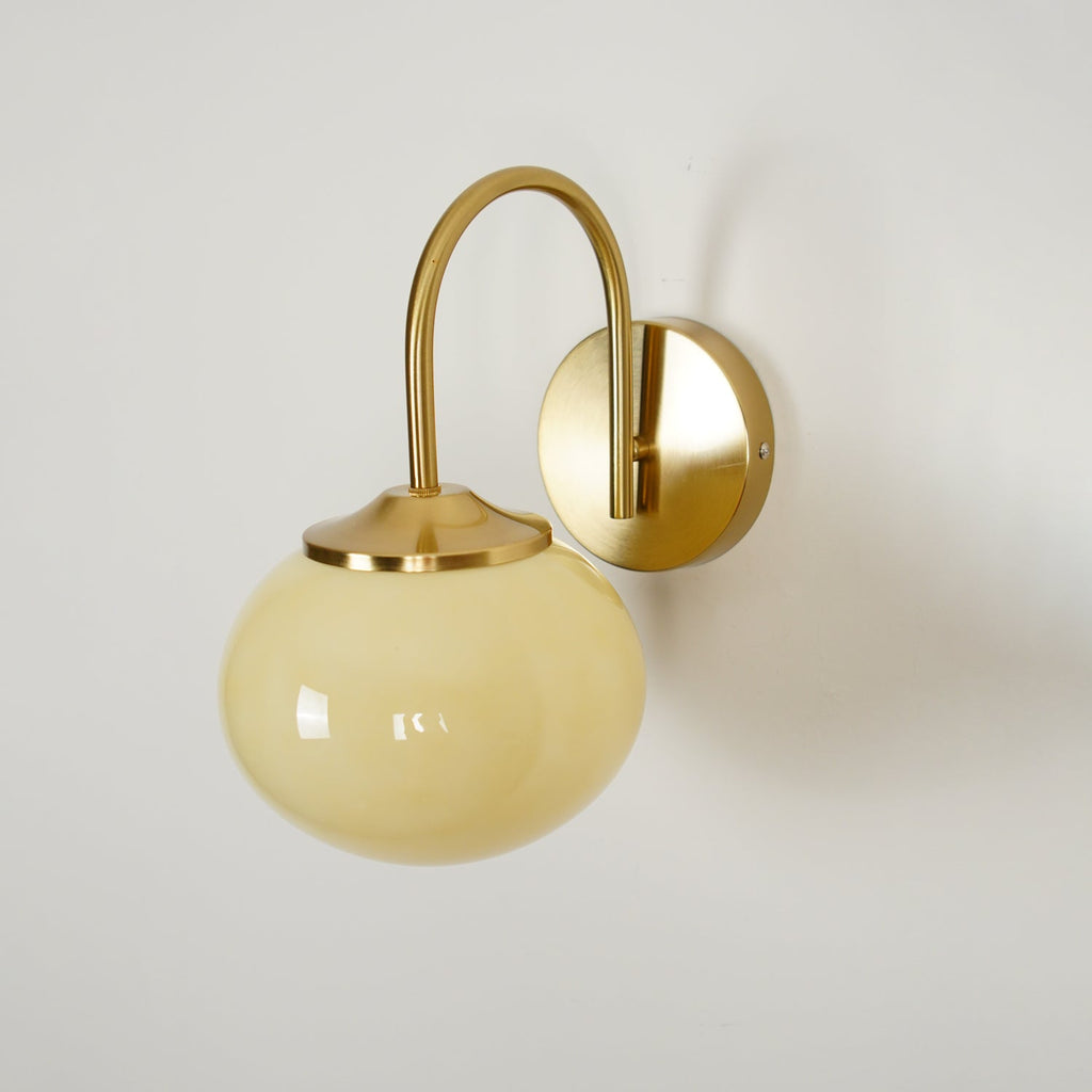 Angled view of this Clérachic wall light in copper and beige glass, unlit, on a plain white background.