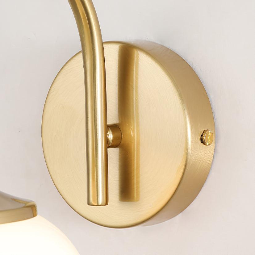 Close view of the copper wall plate and arm on this Clérachic wall light, with the glass shade just visible below.