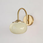 A plain white wall sets off this Clérachic wall light in copper and beige glass, unlit, shown at an angle.