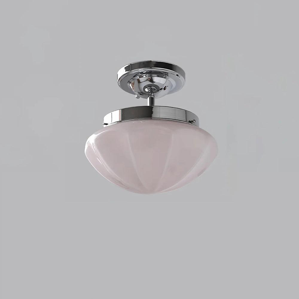 Marta ceiling light shown lit with a warm Edison glow