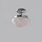 Marta ceiling light shown lit with a warm Edison glow