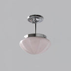 Glass-shade ceiling lights hung at staggered heights together