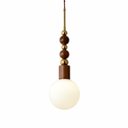 Ash wood bead pendant light with copper hardware, lit warm