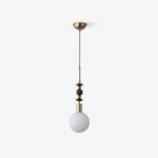 Maru wood-bead pendant light hanging against a soft backdrop