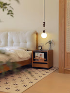 Wood-bead pendant light with white glass shade, lit warm