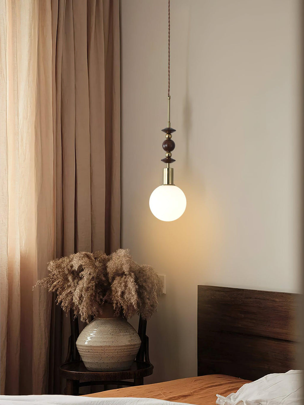 Pendant light with strung wood beads and walnut hardware