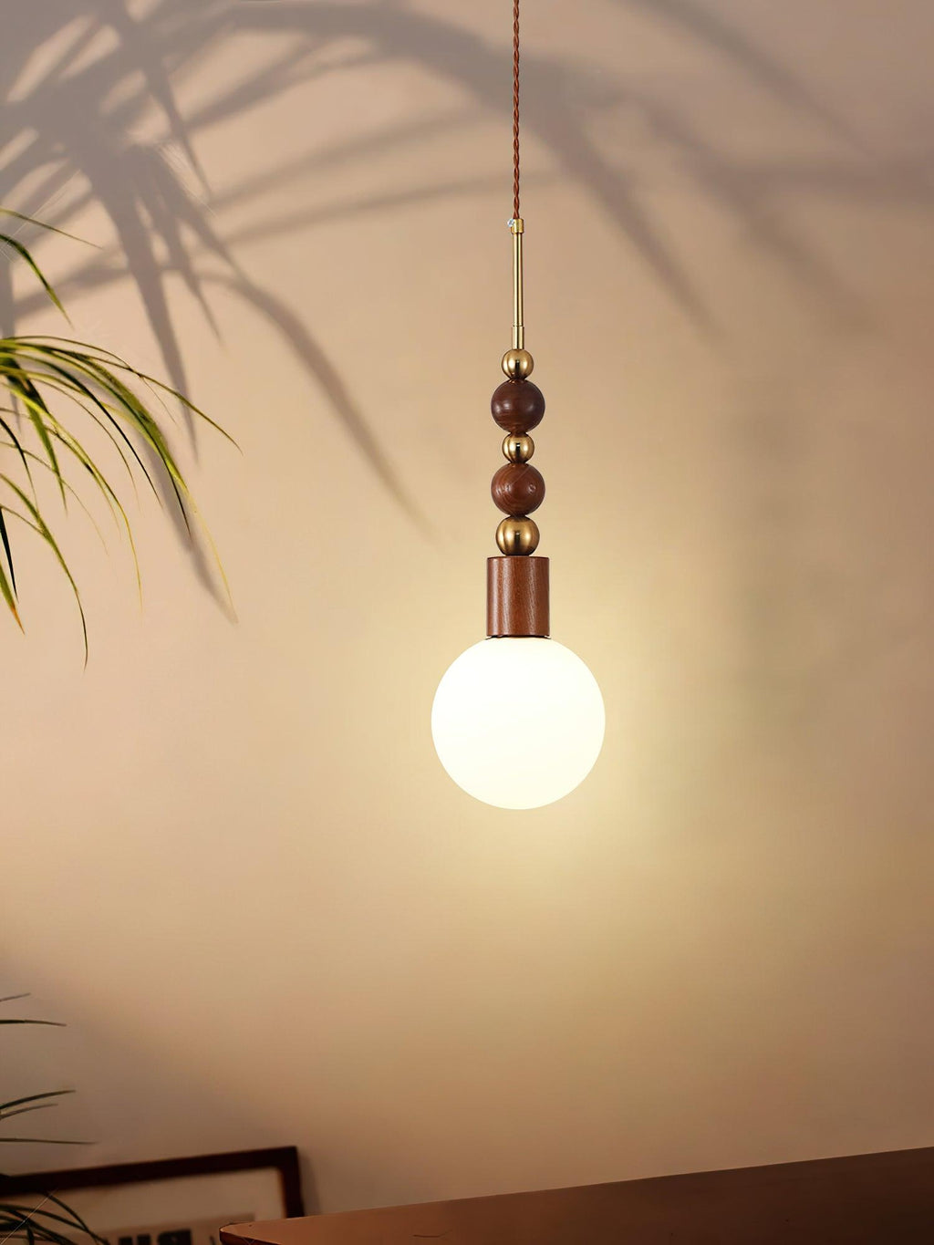 Maru pendant light with ash wood beads in a bright room