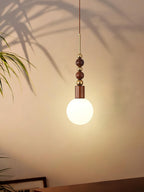 Maru pendant light with ash wood beads in a bright room