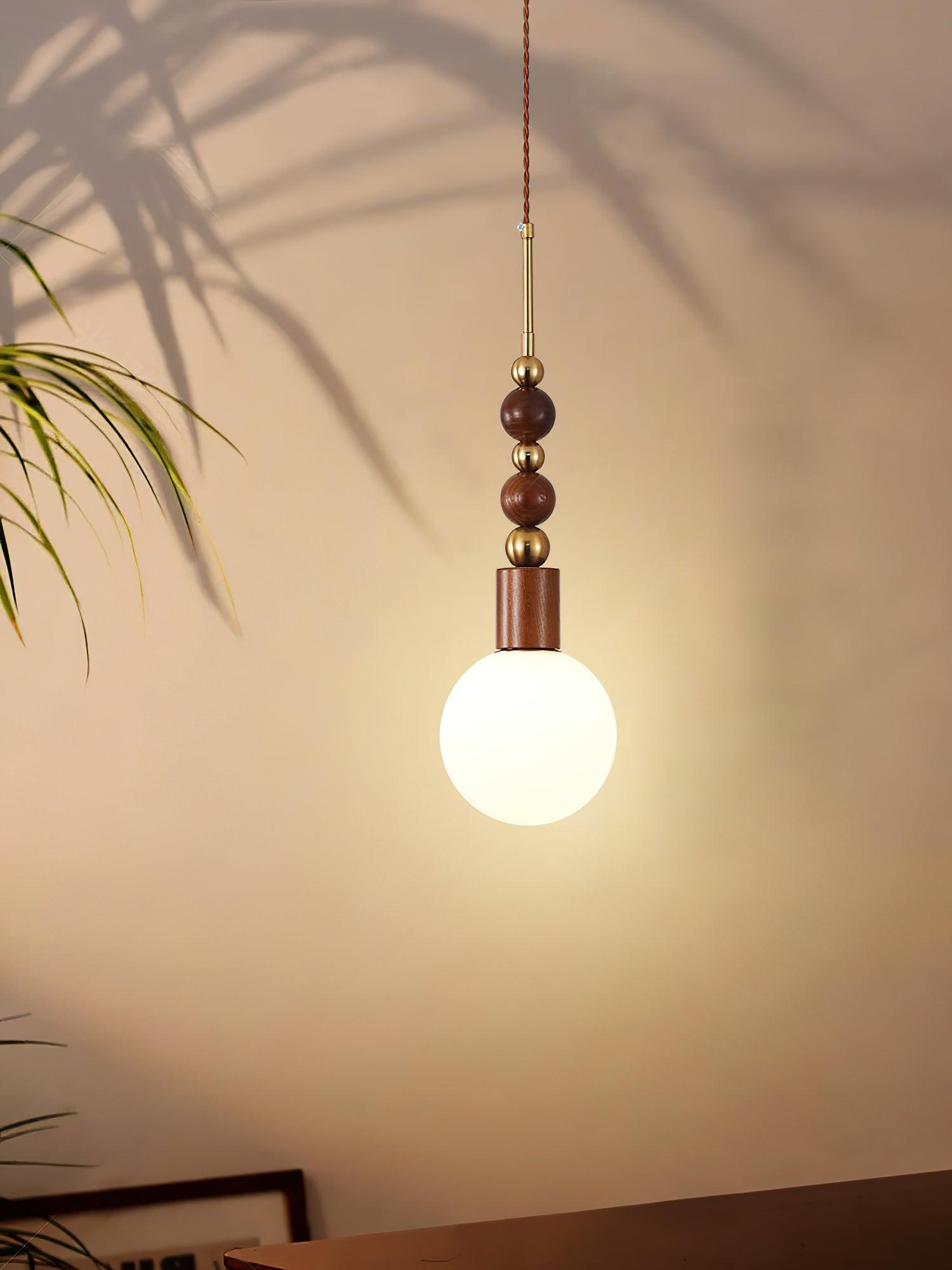 Maru pendant light with ash wood beads in a bright room