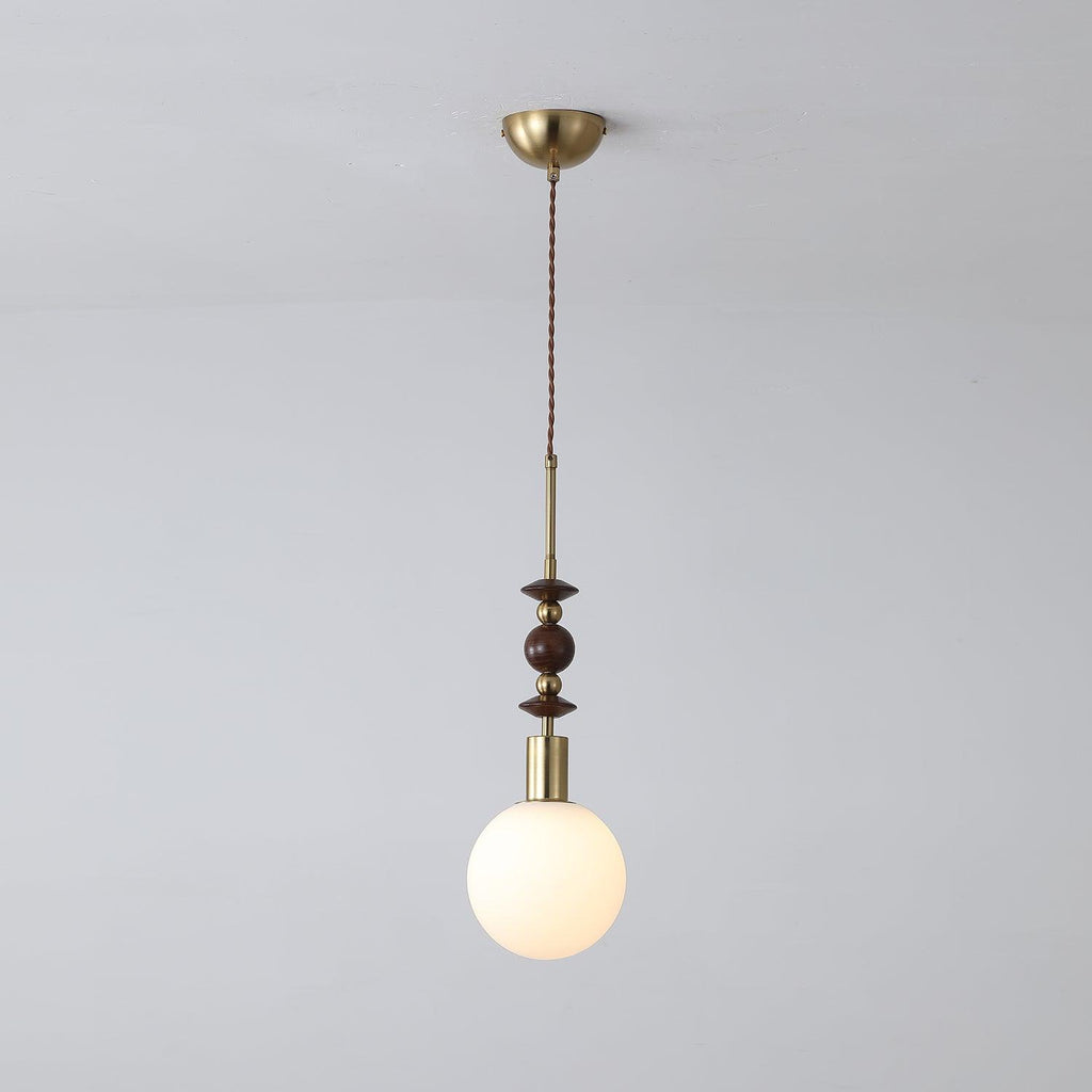 Wood-bead pendant light hanging above a warm interior space