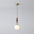 Wood-bead pendant light hanging above a warm interior space