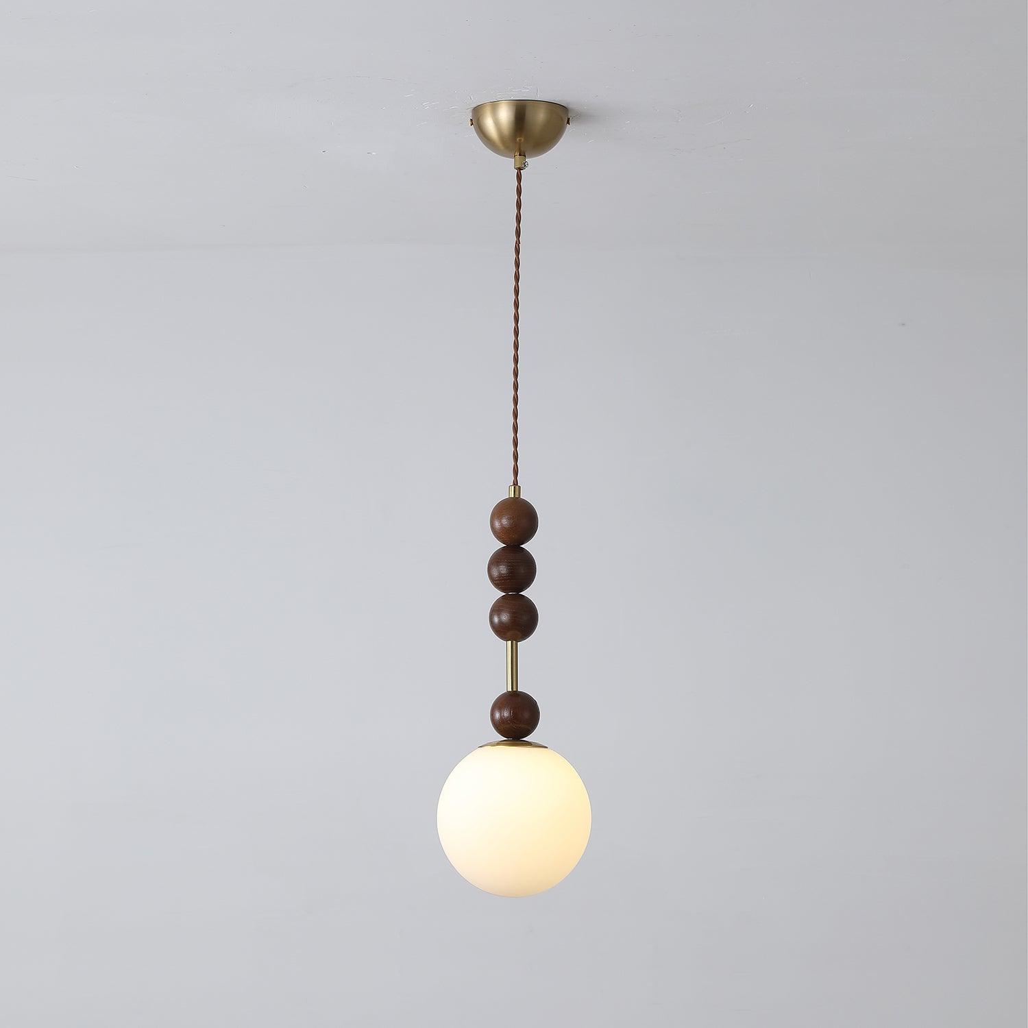 Maru pendant light with strung ash wood beads and glass shade