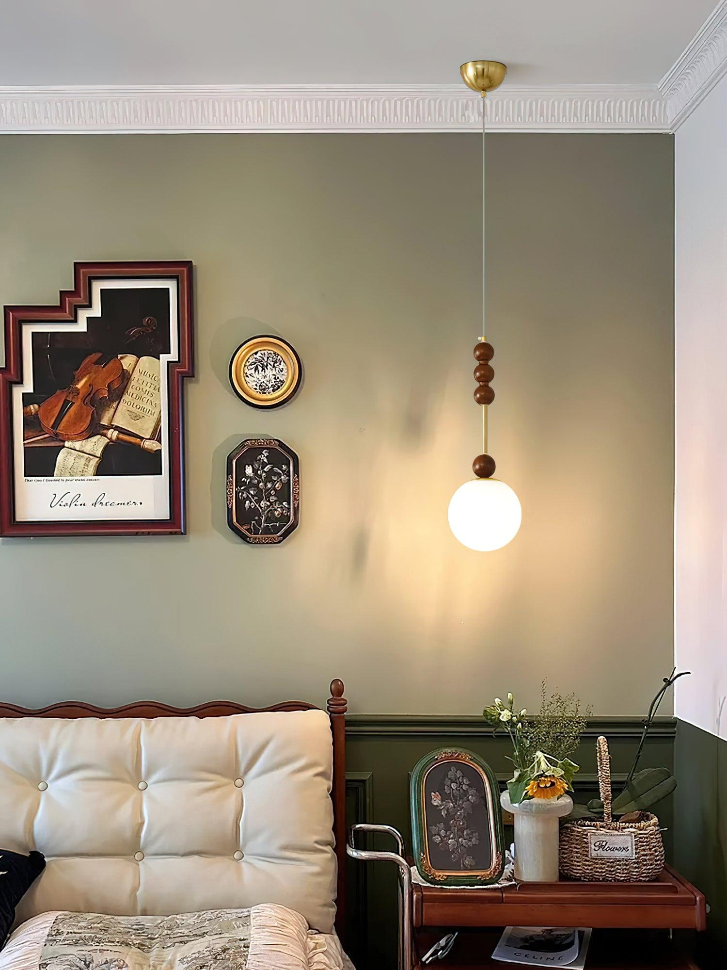 Pendant light with turned wood beads and copper finish