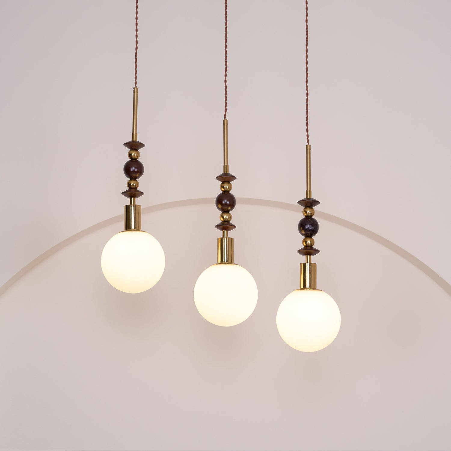 Pendant light with strung ash wood beads and glass shade