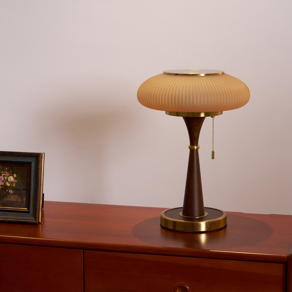 Mushroom-shade table lamp on a side table near a window