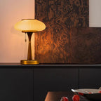 Matsutake table lamp shown lit beside framed wall art
