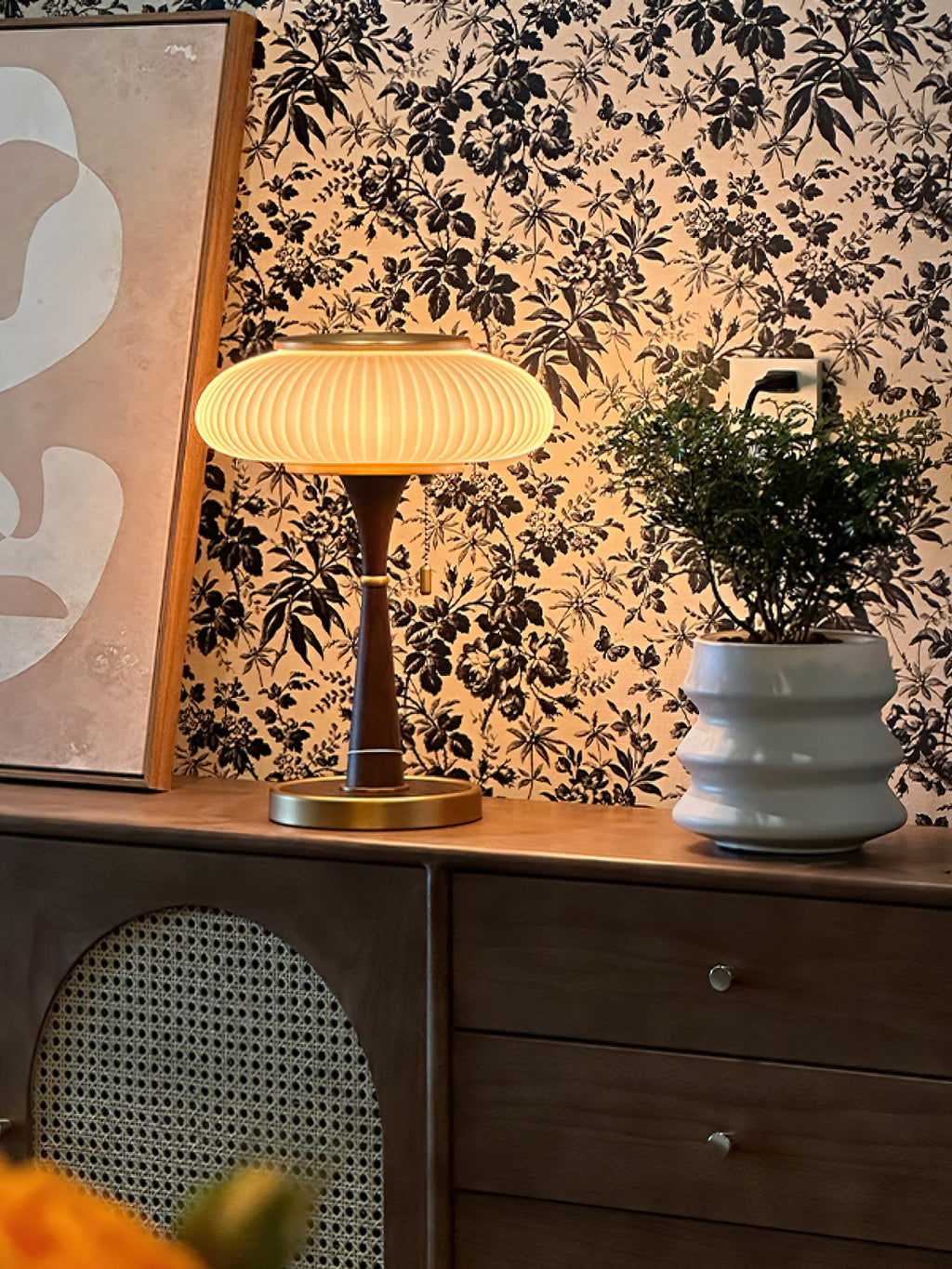 Mushroom glass table lamp glowing warm on a desk surface