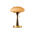 Matsutake table lamp glowing warm beside a soft armchair