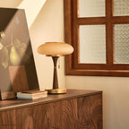 Mushroom-cap table lamp shown lit on a console surface