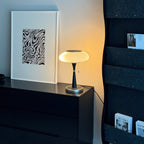 Mushroom-cap table lamp with curved base shown unlit