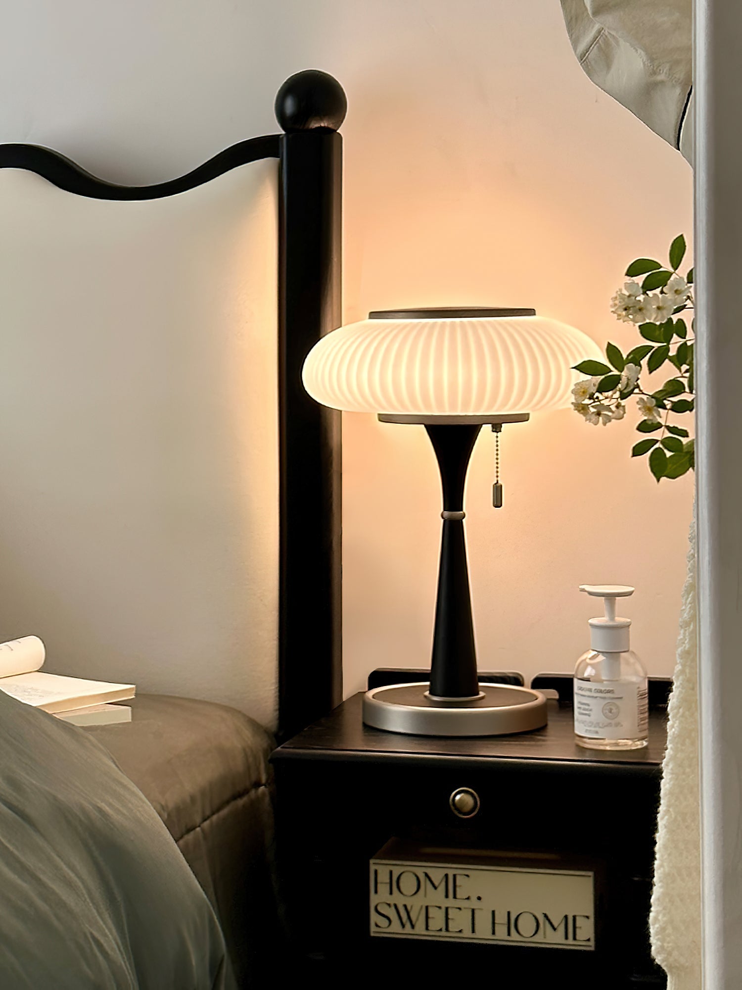 Table lamp with glass cap and metal base on a wood table