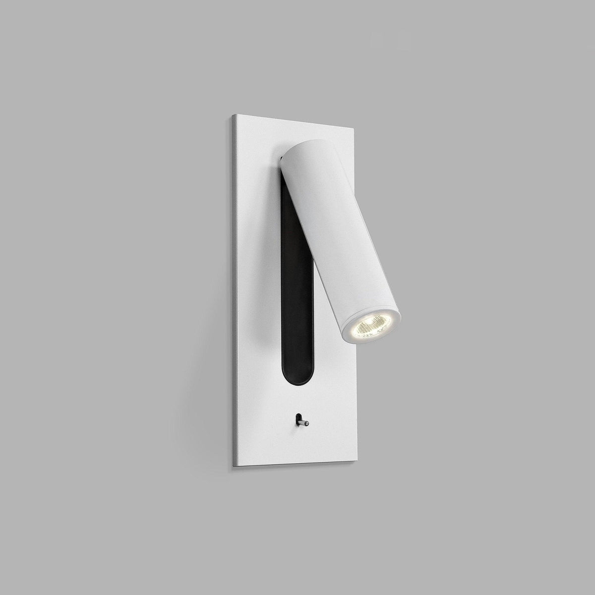 This Clérachic reading light in matt white is mounted on a plain grey wall, head angled downward, unlit.