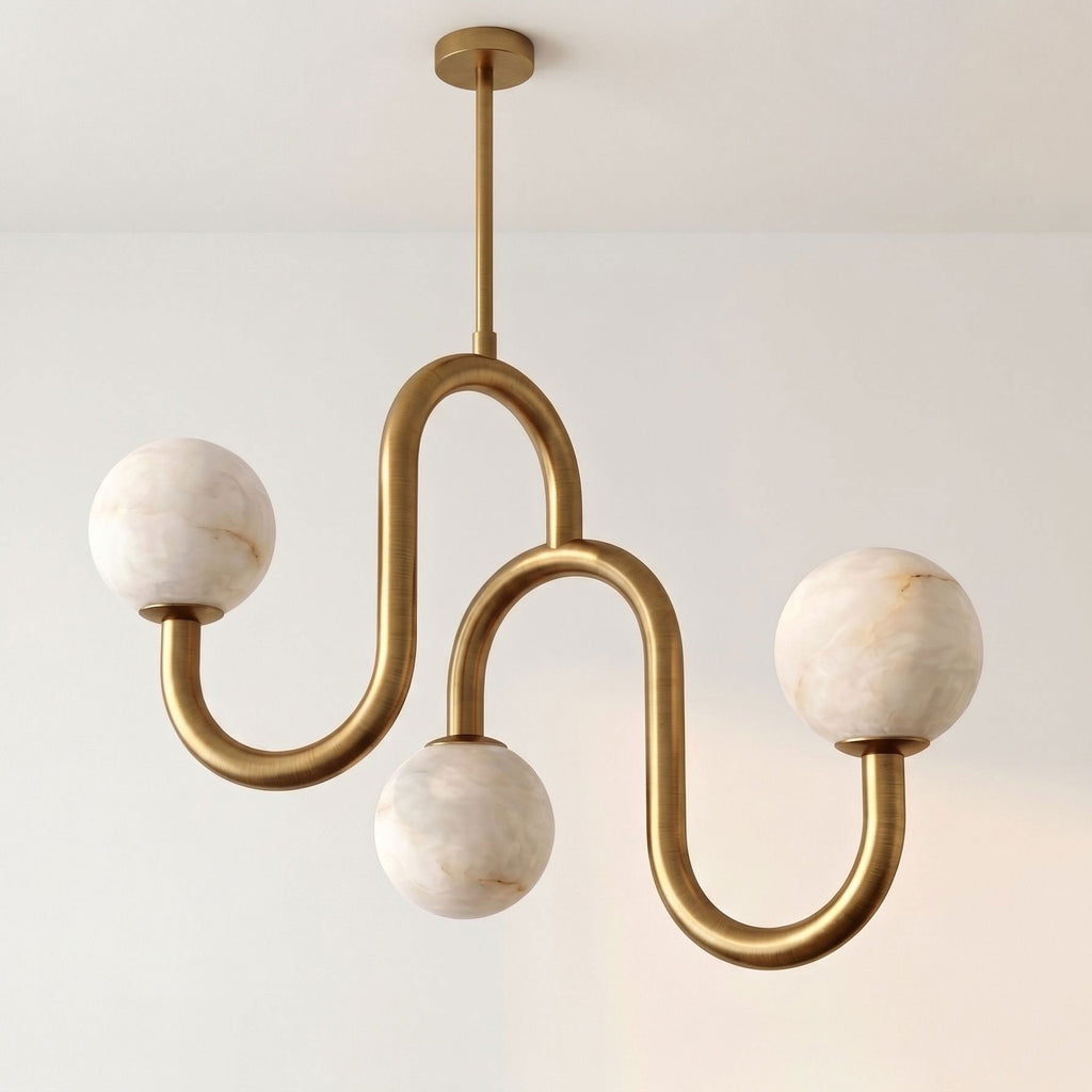 Lit against a plain wall with no other furniture in view, this Clérachic chandelier shows off its brass finish and alabaster globes.