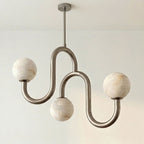 Set on white, this Clérachic chandelier's nickel finish highlights the veining in its three alabaster globes.