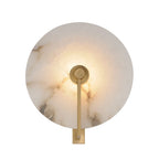 Front-facing studio shot of this Clérachic wall sconce in brushed brass, the disc glowing warm from within.