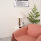 Clérachic table lamp shown again in the corner, from a slightly different angle with more of the armchair in view.