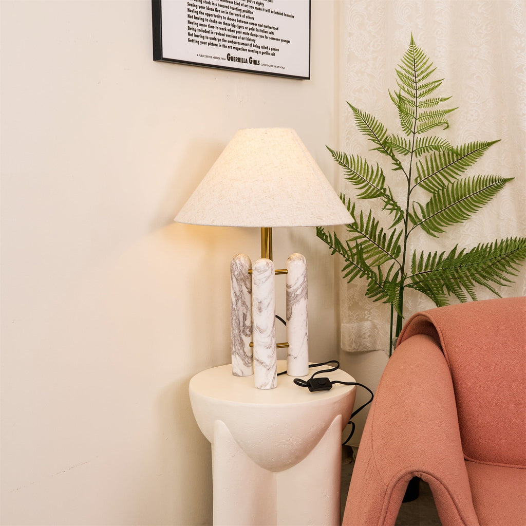 Clérachic table lamp in the same corner, angled to show more of the coral armchair's seat beside the fern.