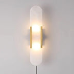 Brass Kristy alabaster wall lamp lit almost square on, two bulb glows visible through the stone