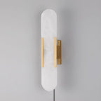 Brass Kristy sconce unlit at a right-hand angle, cord running down from the wall bracket