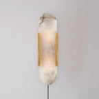 Brass Kristy sconce on a grey wall, the grey-brown veining of the natural alabaster clearly visible
